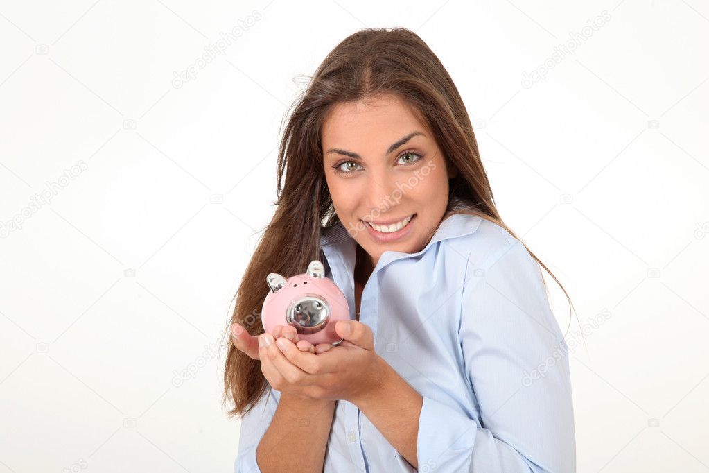 Portrait of beautiful woman holding piggybank