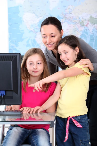 Öğretmen çocukların önünde masaüstü bilgisayar ile — Stok fotoğraf