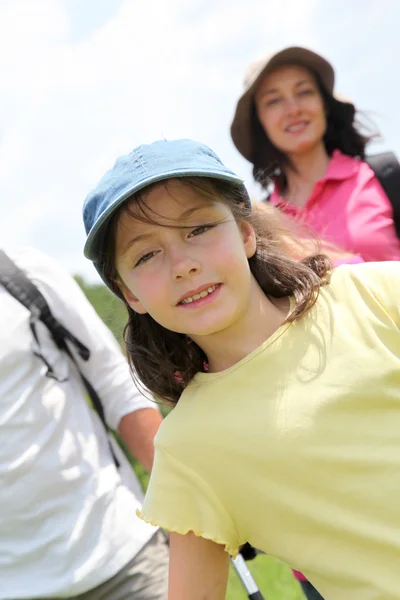 Portrait of young girl hiking with family — Stock Photo, Image