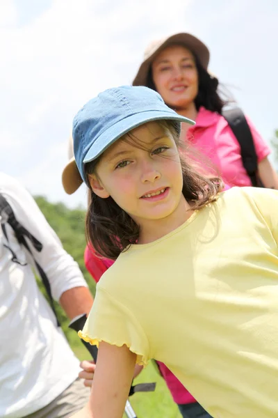 Portrait of young girl hiking with family — Stock Photo, Image