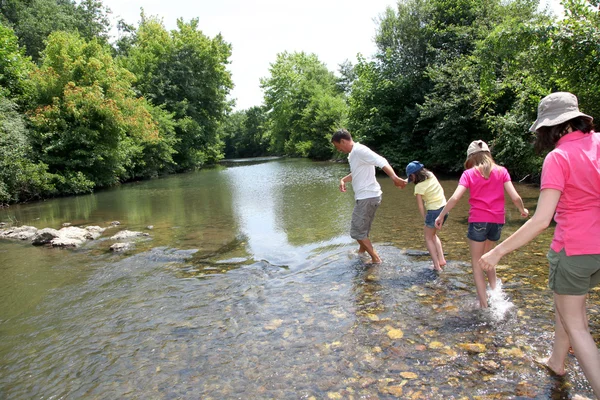 Familjen korsar floden i sommar — Stockfoto