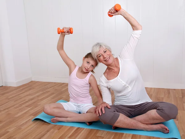 Grandmother and young girl doing fitness exercises — Stock Photo, Image