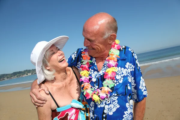 Happy senior couple at tropical beach — Stock Photo, Image