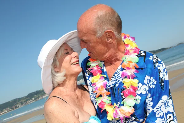 Happy senior couple at tropical beach — Stock Photo, Image