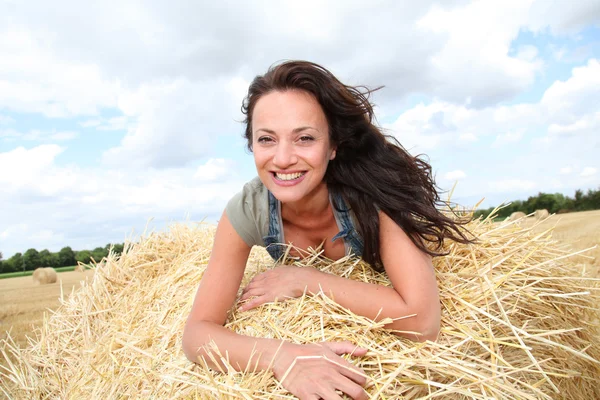 Beautiful woman laying down bale — Stock Photo, Image