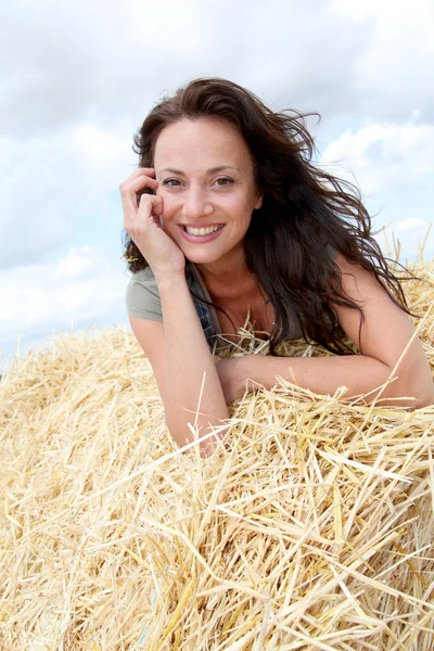 Beautiful woman laying down bale — Stock Photo, Image