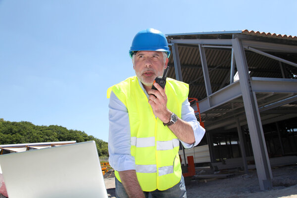Site manager using walkie-talkie