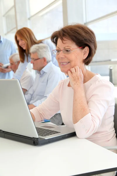 Senior woman attending business training — Stock Photo, Image