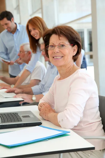 Senior woman attending business training — Stock Photo, Image