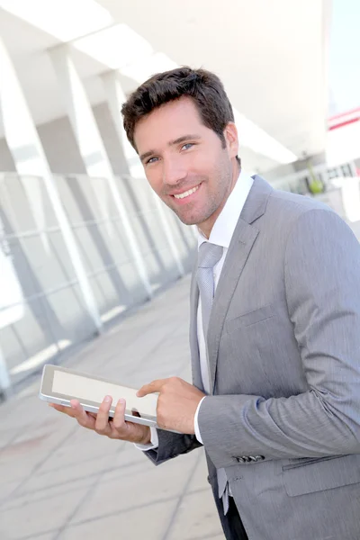 Businessman using electronic tablet outside a building — Stock Photo, Image