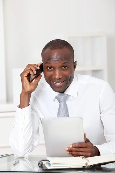 Businessman sitting at his desk in office — Stock Photo, Image