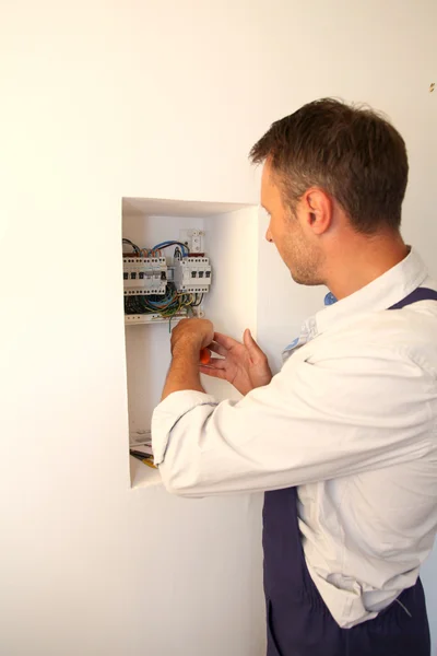 Electrician installing electric meter Royalty Free Stock Photos