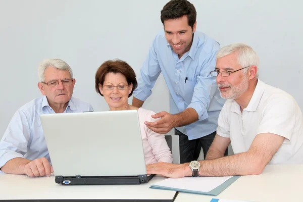 Group of senior attending job search meeting Stock Image