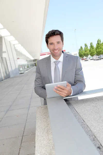 Businessman using electronic tablet outside a building Royalty Free Stock Images