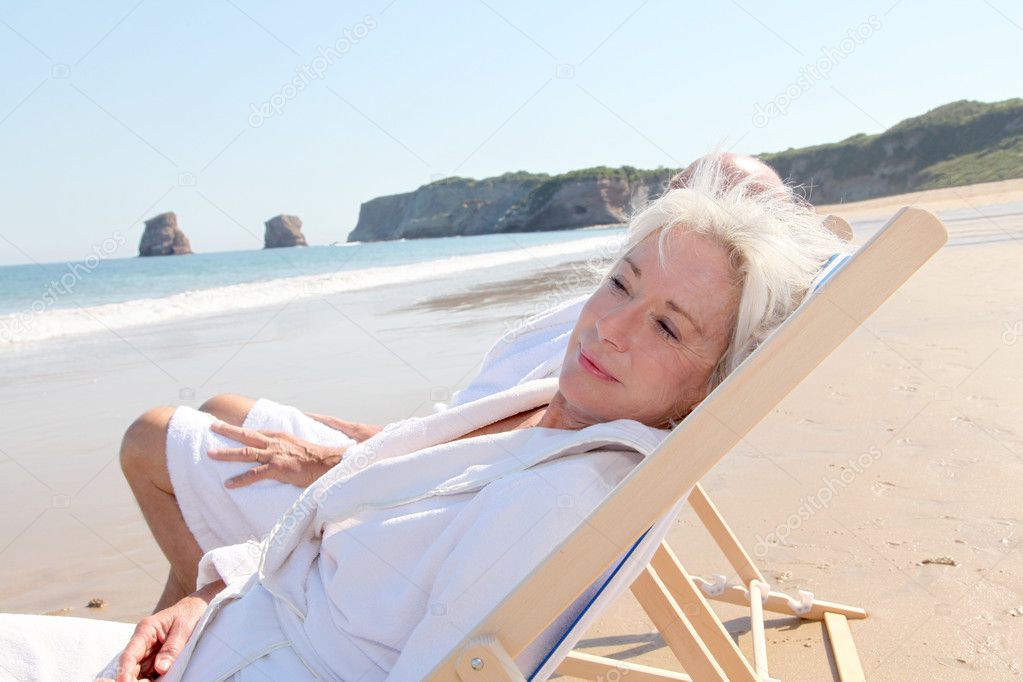 Portrait of senior woman relaxing in longchair