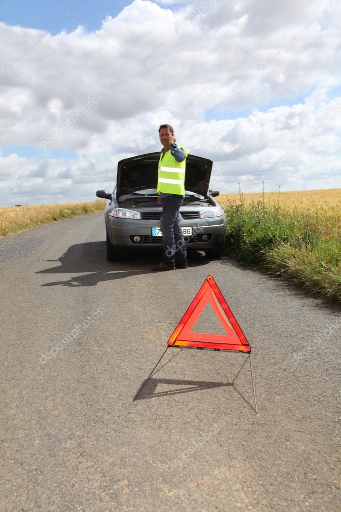 Man on the road with car breakdown