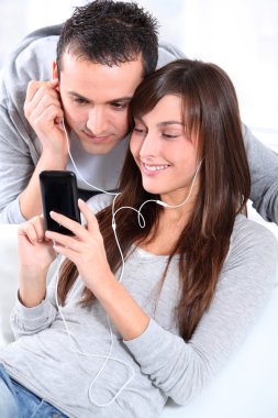 genç bir çift cep telefonu ile müzik dinlemek