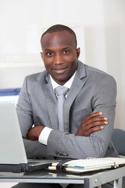 Businessman sitting at his desk in office — Stock Photo, Image