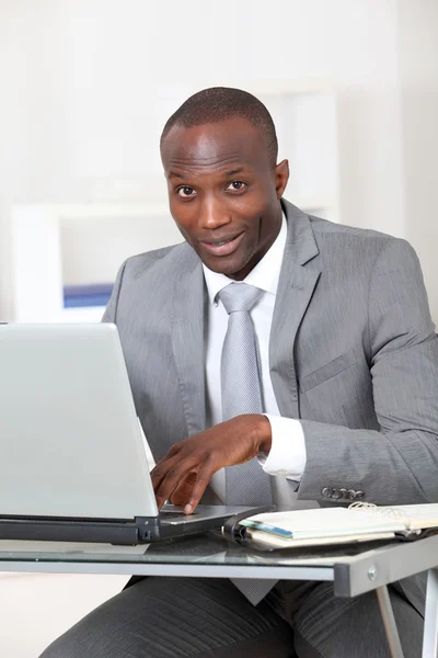 Businessman sitting at his desk in office — Stock Photo, Image