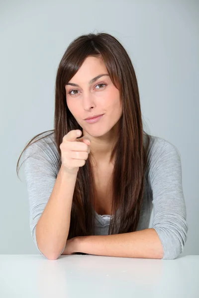 Junge Frau zeigt mit dem Finger an — Stockfoto