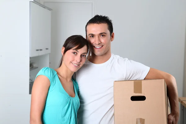 Jong koppel dozen uitvoering in nieuwe huis — Stockfoto