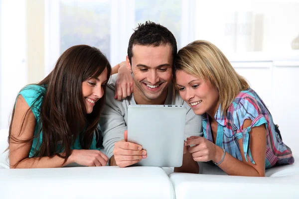 Group of friends laying in sofa at home — Stock Photo, Image