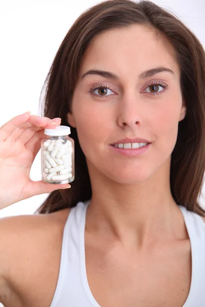 Closeup of woman holding bottle of pills — Stock Photo, Image