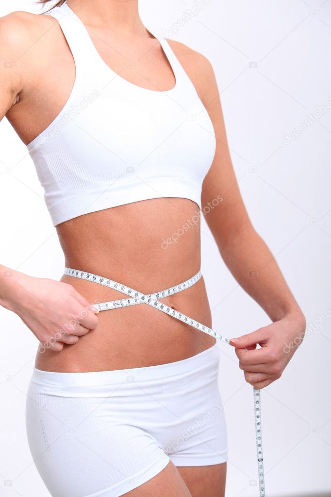 Closeup of tape measure around woman waist