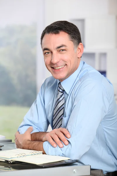 Closeup of smiling businessman in the office — Stock Photo, Image