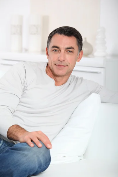 Closeup of handsome man relaxing in sofa — Stock Photo, Image