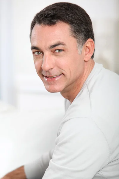 Closeup of handsome man relaxing in sofa — Stock Photo, Image