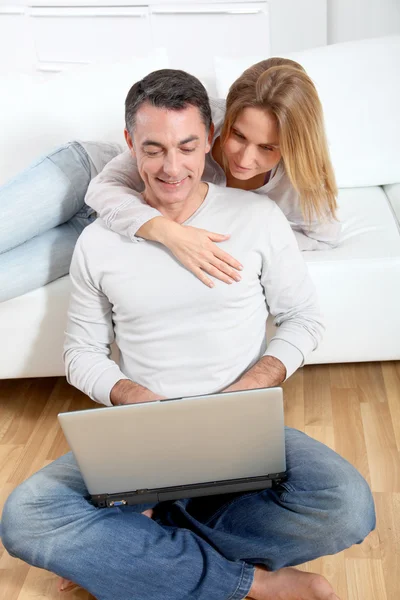 Feliz casal surfar na internet em casa — Fotografia de Stock