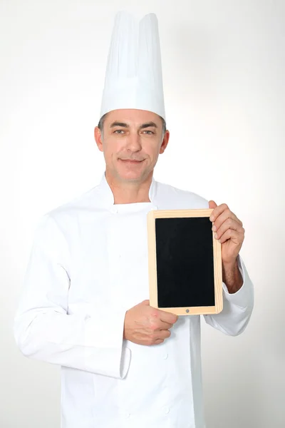 Chef holding black board for menu — Stock Photo, Image