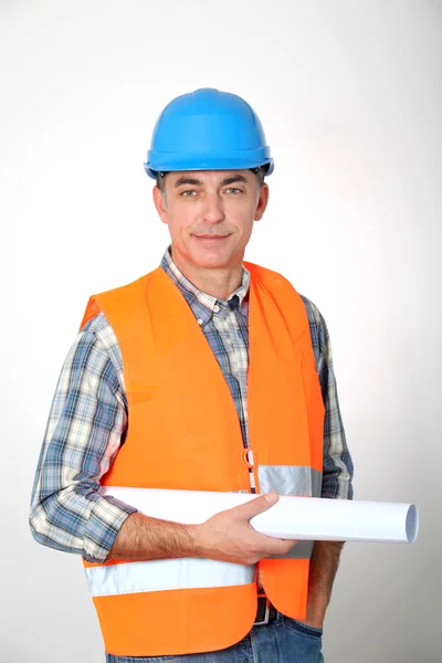 Entrepreneur standing with plan — Stock Photo, Image
