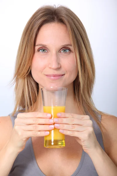 Closeup of beautiful blond woman drinking fruit juice — Stock Photo, Image