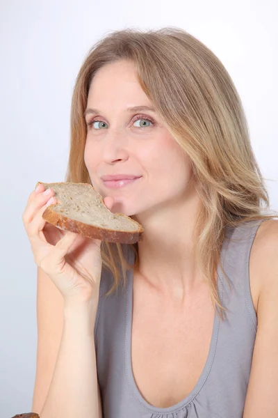 Closeup of beautiful woman eating slice of bread — Stock Photo, Image