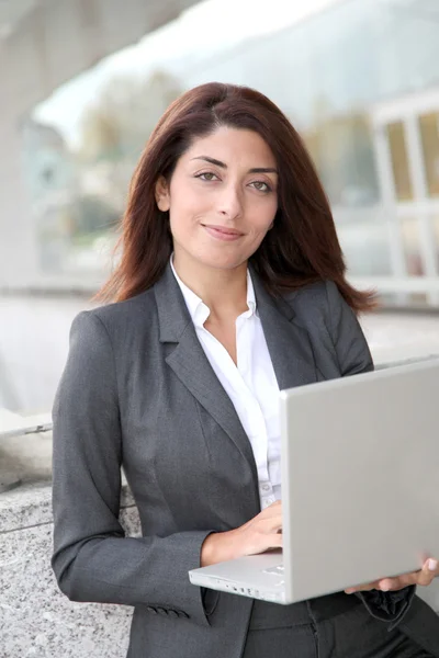Kobieta z laptop komputer stojący poza — Zdjęcie stockowe