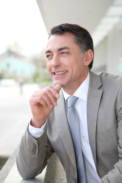 Businessman standing outside modern building — Stock Photo, Image