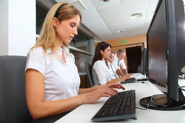 Blond businesswoman with headset on — Stock Photo, Image