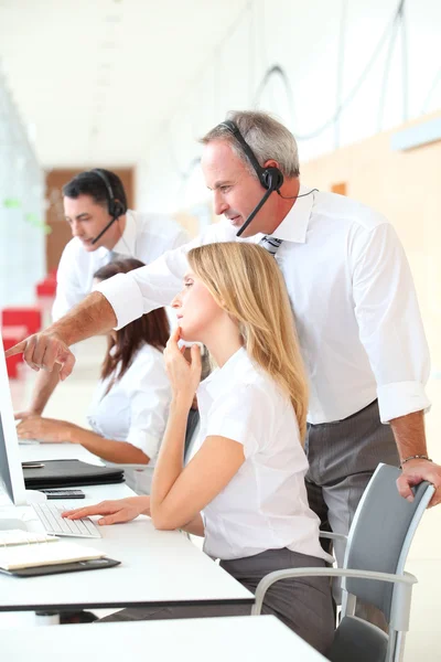 Business working in front of computer with headphones — Stock Photo, Image