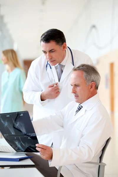 Médicos mirando radiografía en el hospital — Foto de Stock