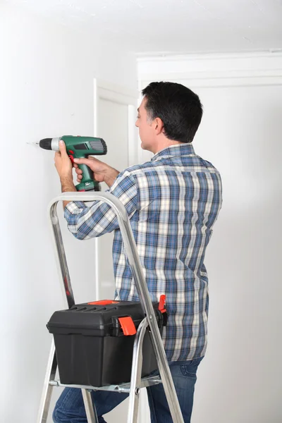 Man using electric drill at home — Stock Photo, Image