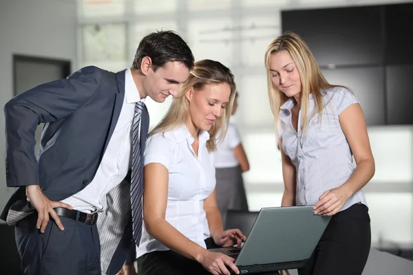 Co-workers with laptop computer in the office — Stock Photo, Image