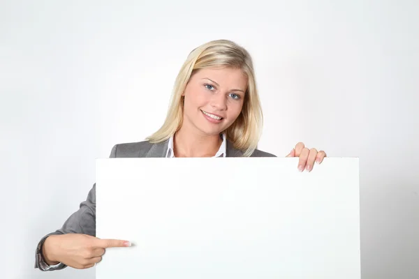 Businesswoman holding white panel — Stock Photo, Image