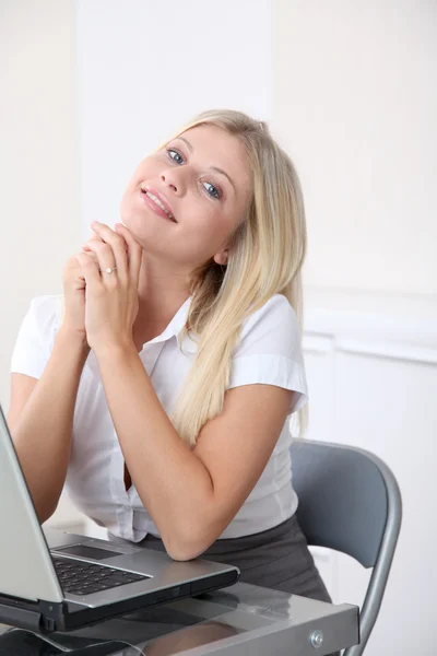 Blond businesswoman doing funny faces in the office — Stock Photo, Image