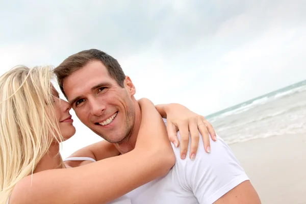 Pareja divirtiéndose en una playa de arena — Foto de Stock