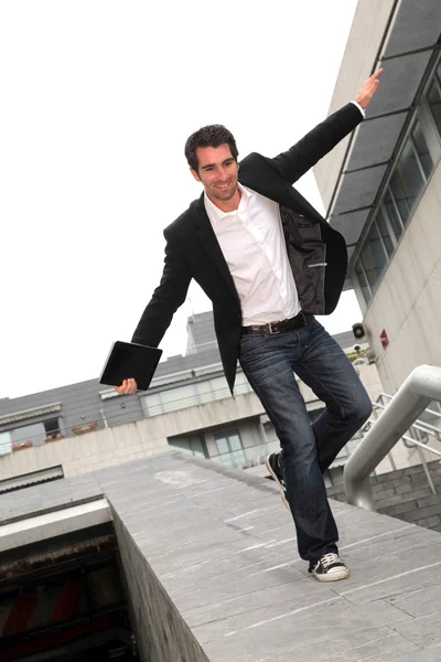 Man running downstairs with stretched arms — Stock Photo, Image