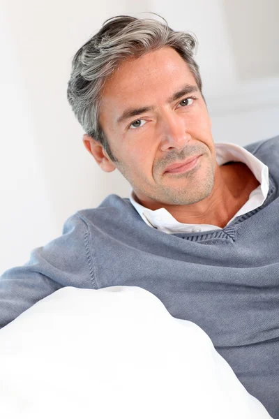 Handsome man relaxing in sofa at home — Stock Photo, Image