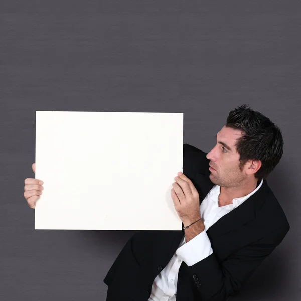 Funny salesman holding whiteboard — Stock Photo, Image