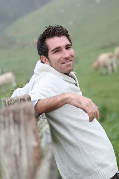 Portrait of breeder leaning on fence — Stock Photo, Image